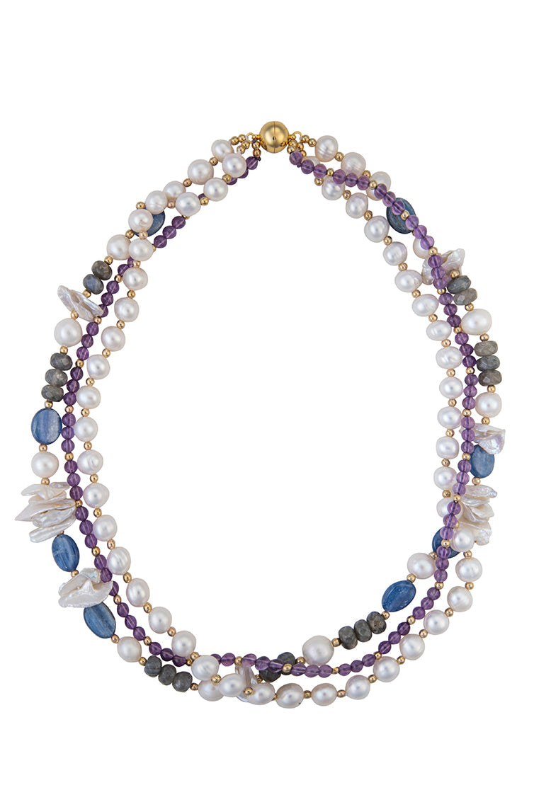Three-strand necklace featuring freshwater pearls, purple amethyst beads, blue lapis stones, grey labradorite, and small gold beads.