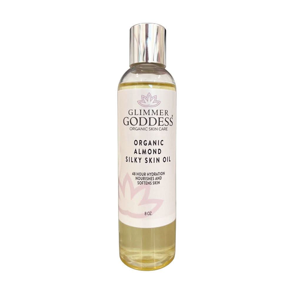 Transparent bottle of pale-yellow Glimmer Goddess Organic Almond Silky Skin Oil