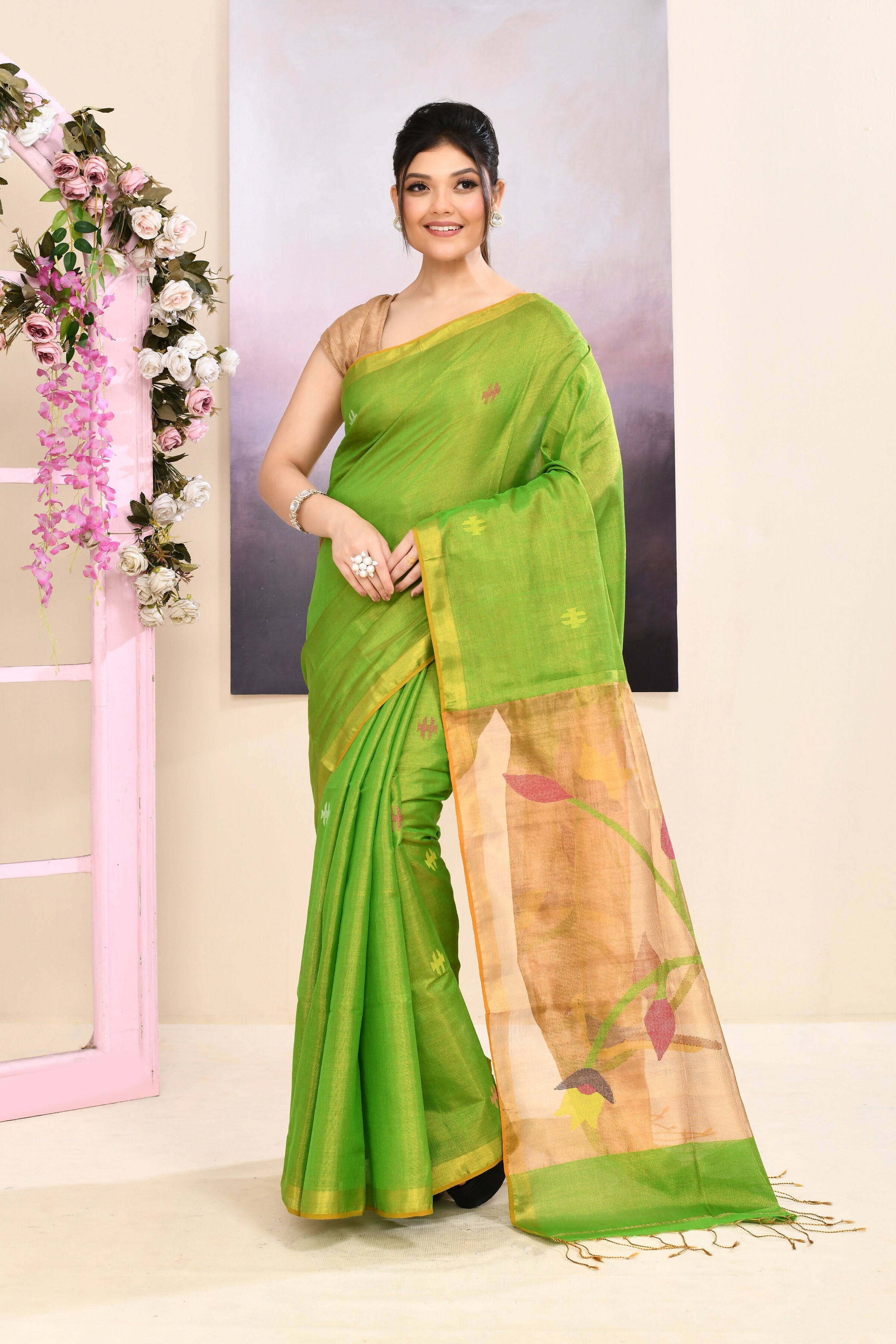 Green Tissue Jamdani Saree with detailed embellishments and a light-reflecting finish.