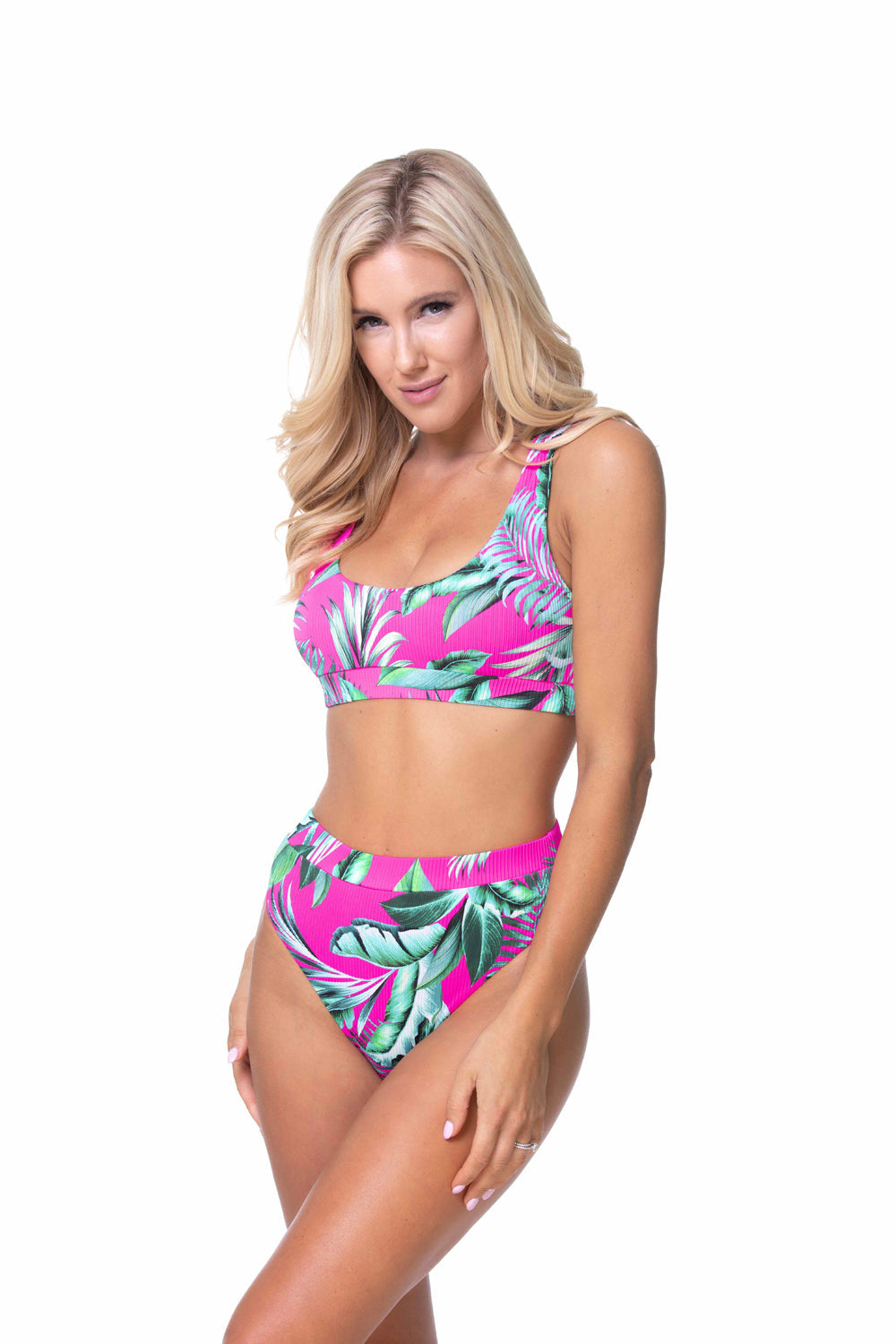 A woman wearing a ribbed tropical-inspired scoop neck high-leg bikini set with an elasticized band.