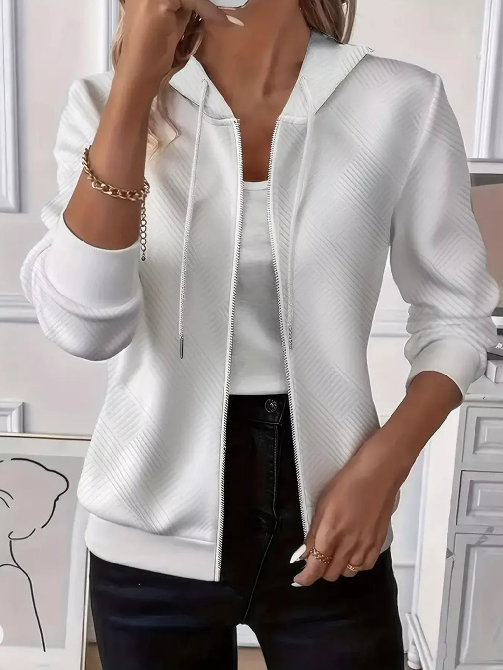 Woman wearing a textured zip-up hoodie with drawstring detail, showing casual fit and high-quality fabric.