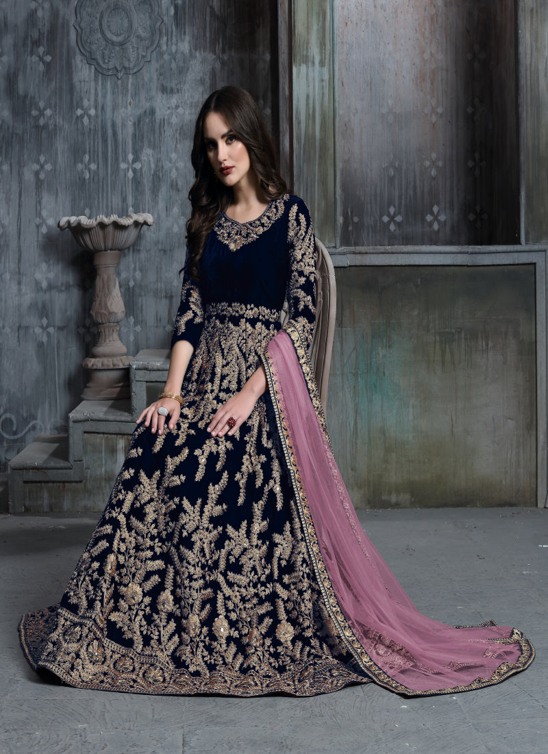 A dark green velvet Patiala suit with intricate embroidery details for festive occasions.