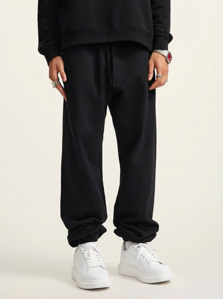 A pair of black heavyweight 440 GSM cotton joggers with a relaxed, loose fit.