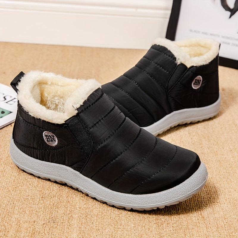 Black waterproof women's ankle boots with plush white interior lining and grey soles.