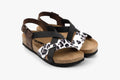 Women's orthopedic leather sandals in brown and black with animal print detail and adjustable ankle buckle.