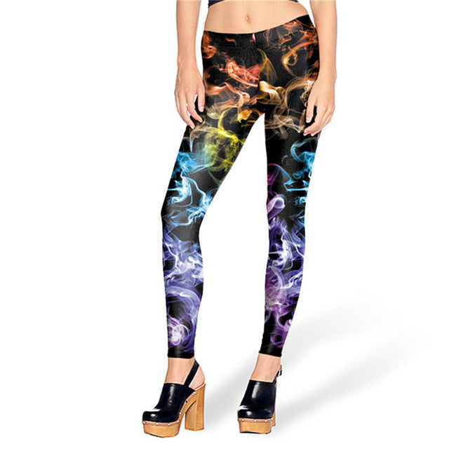 Woman wearing multicolored colored smoke print leggings on a black background, showcasing the vibrant design and comfortable fit.