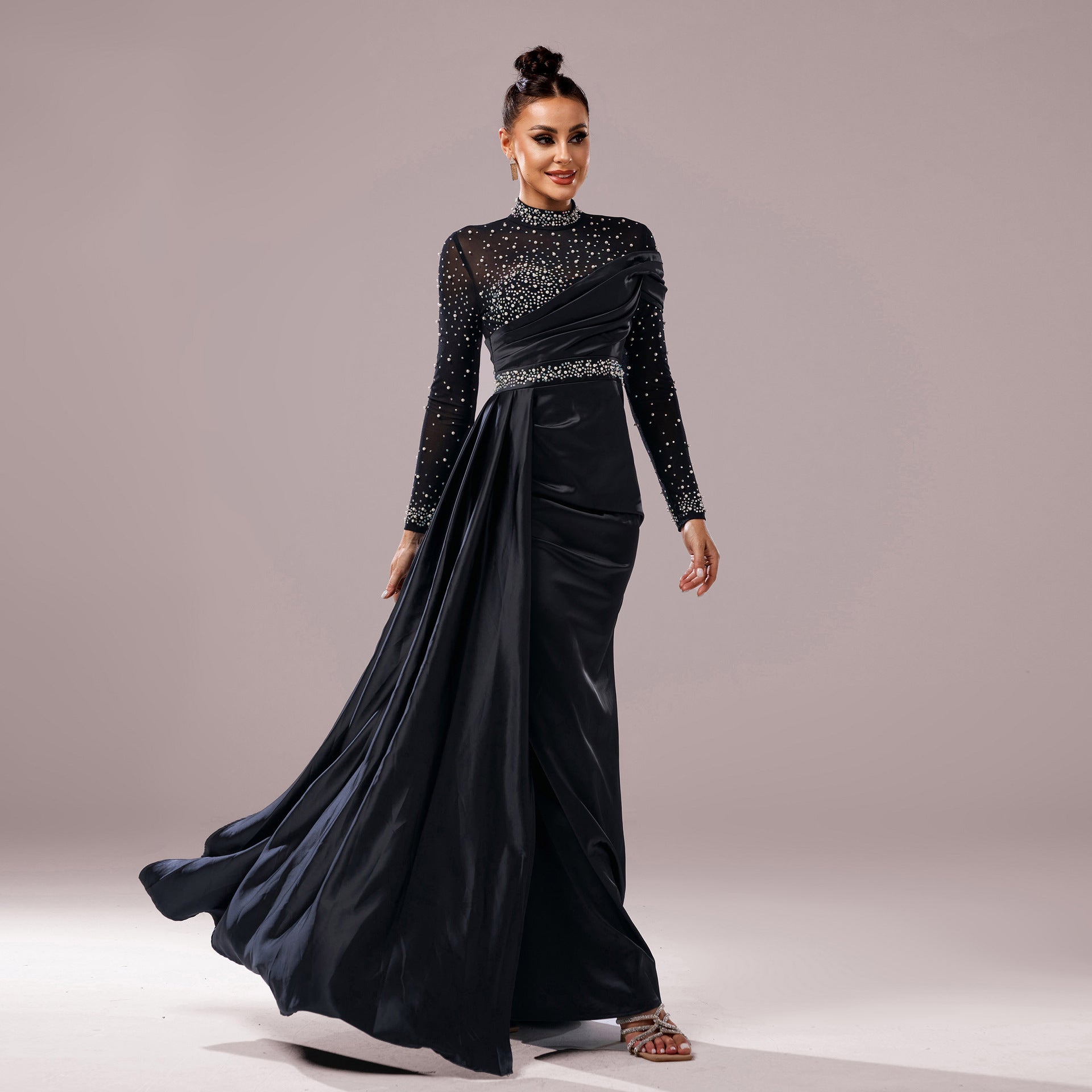 Black long sleeve slim-fit evening dress with fishtail hem, sequin and pearl detailing.