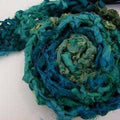 Luxurious handmade scarf crafted from teal and emerald green recycled silk ribbon
