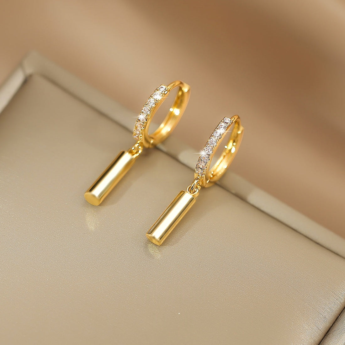 Cylindrical geometric 14k gold-plated clip-on earrings with a protective nano-coating finish.
