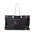 An oversized wide-mouthed Weekender Tote bag featuring thick, durable rope handles.