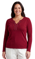 Close up of women's V-neck knit top featuring open crochet detail and jewel trim at the neckline