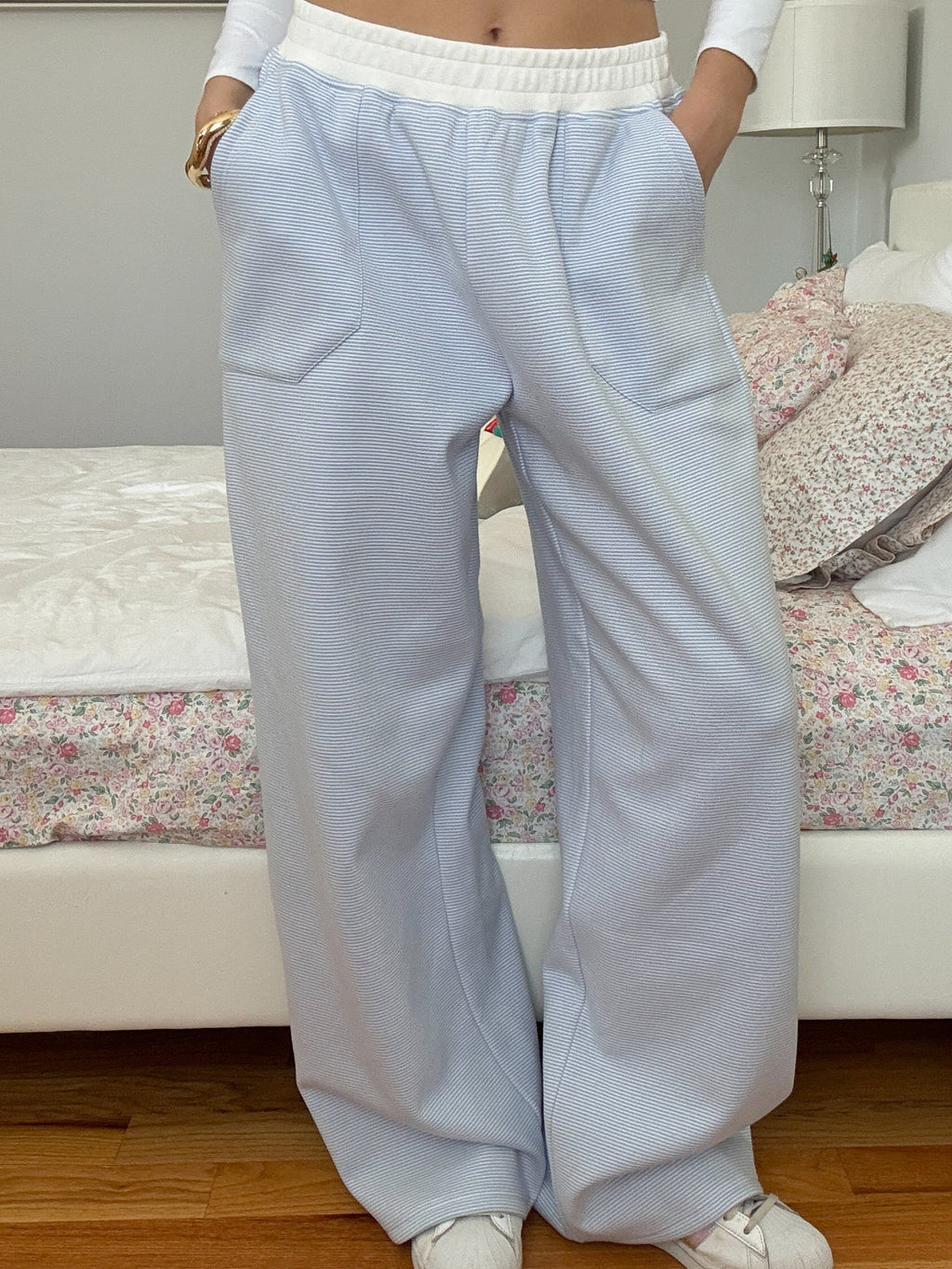 A pair of blue and white mini striped unisex sweatpants featuring a comfortable relaxed fit.