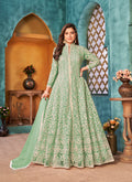A stunning sea green floor-length designer suit in net with cord work embroidery.