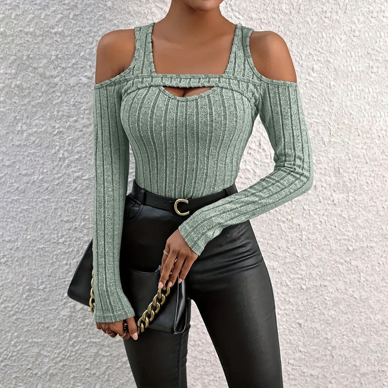Model wearing a fitted ribbed long sleeve top with cold shoulder and cut-out detail