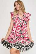 A bohemian style floral print cotton dress with ruffled cap sleeves and a tiered skirt.