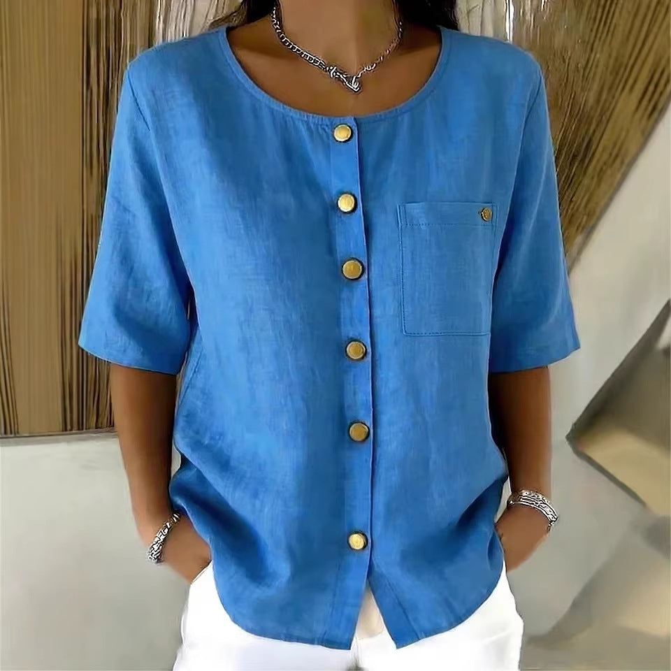 Model wearing a blue crew-neck 3/4 sleeve shirt with gold-tone metal buttons and a chest pocket.
