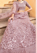 Mauve net lehenga choli with elaborate Zarkhan embroidery