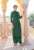 Dark green embroidered muslin and georgette pant style suit with elegant detailing.