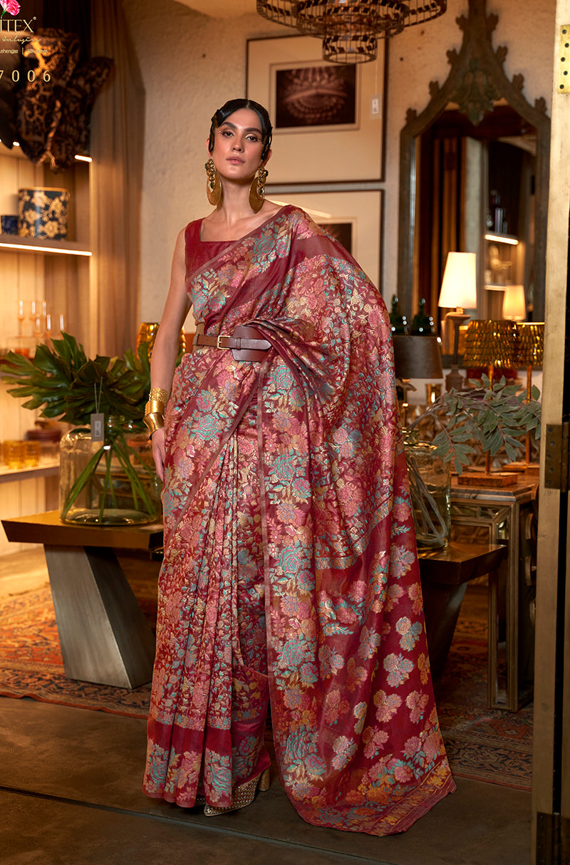 Vibrant red silk saree with artistic printing and a classic border.