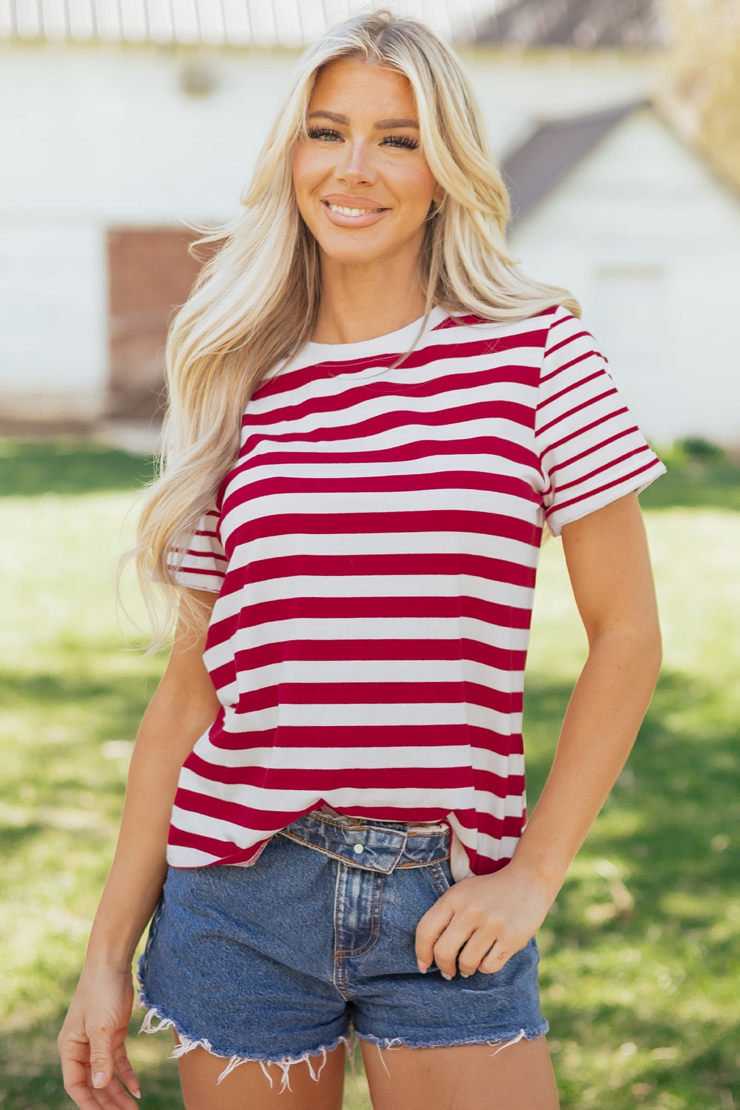 Woman wearing a casual red and white striped patchwork t-shirt with short sleeves