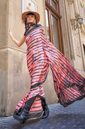 Beautiful peach printed satin saree with a lustrous sheen and trendy design.