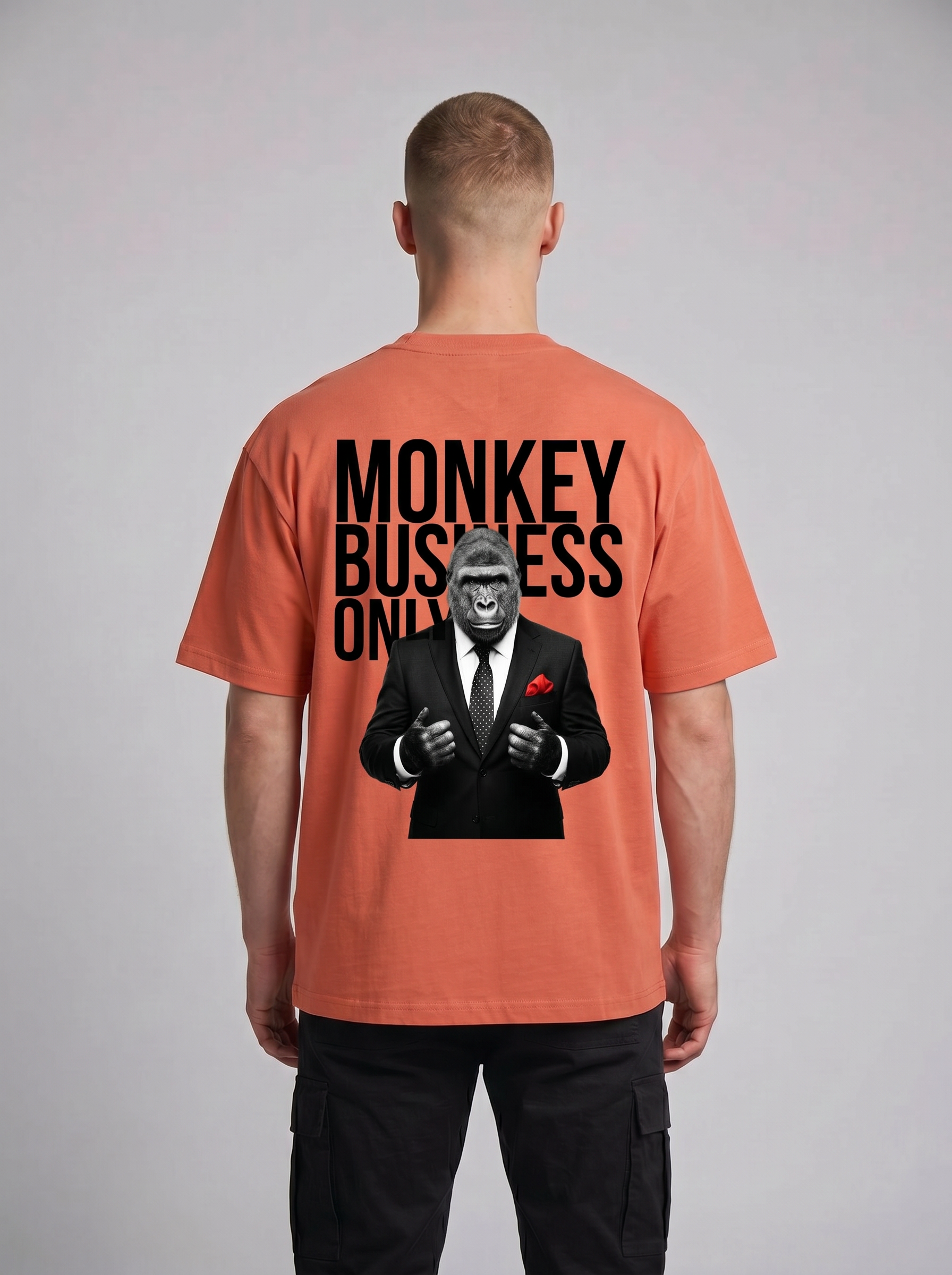 Coral and black oversized graphic tee featuring a sharp-dressed gorilla design.
