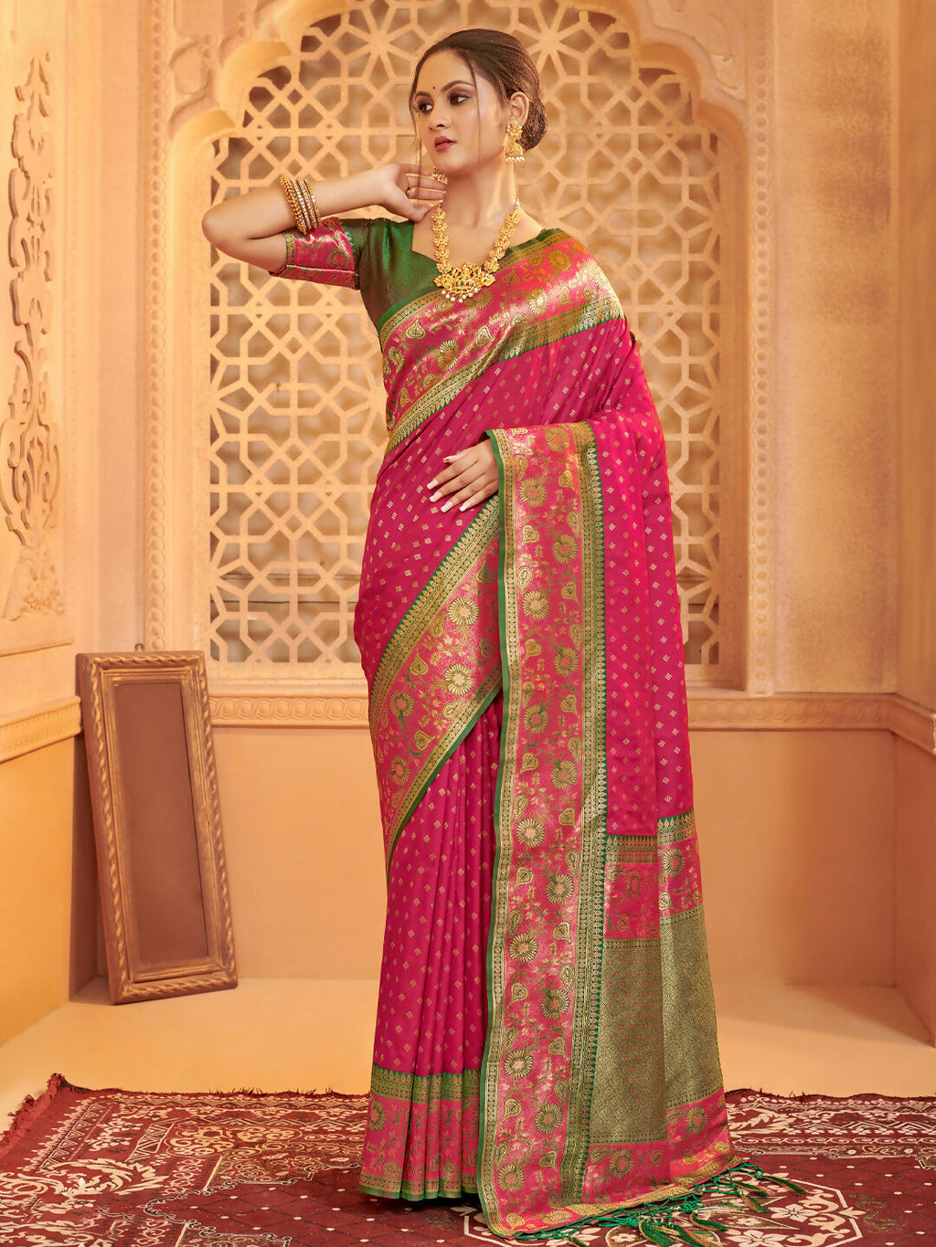 Dark pink silk blend saree with a contrasting green unstitched blouse piece