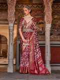 A vibrant red silk saree adorned with classic Ajarak prints and detailed zari work.