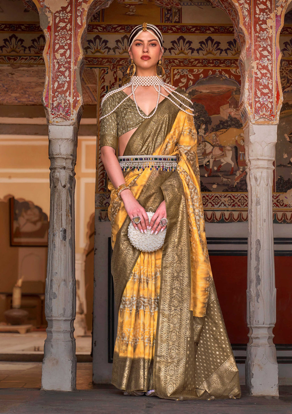 Yellow and Mehendi silk saree featuring Ajarak prints and zari work