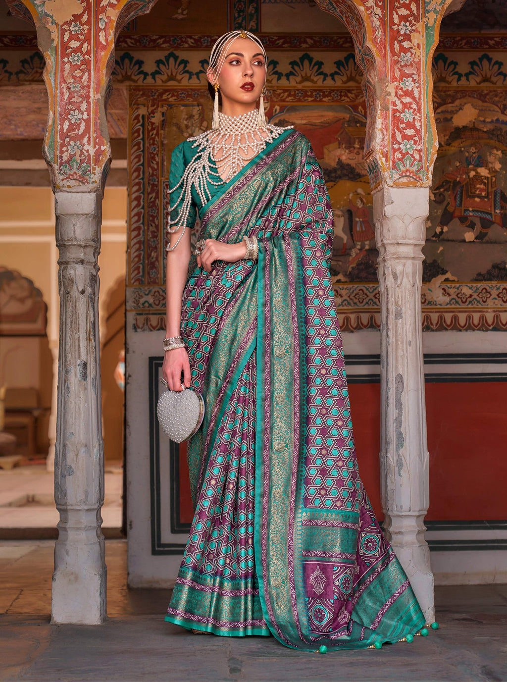 Multi-color silk saree with Turquoise blue tones, traditional Ajrak print, and elegant gold zari border.