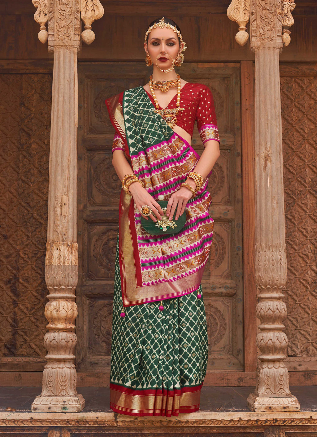 Dark green Patola silk saree with traditional weaving work and blouse piece