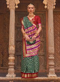 Dark green Patola silk saree with traditional weaving work and blouse piece