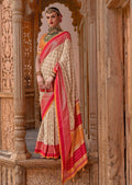Cream color Patola silk saree with intricate weaving patterns and matching blouse