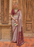 Light Mauve Patola silk saree with intricate gold weaving work and matching blouse piece