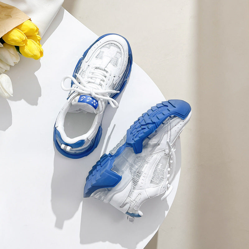 Pair of women's white and blue chunky platform sneakers with clear soles and a casual Harajuku style.