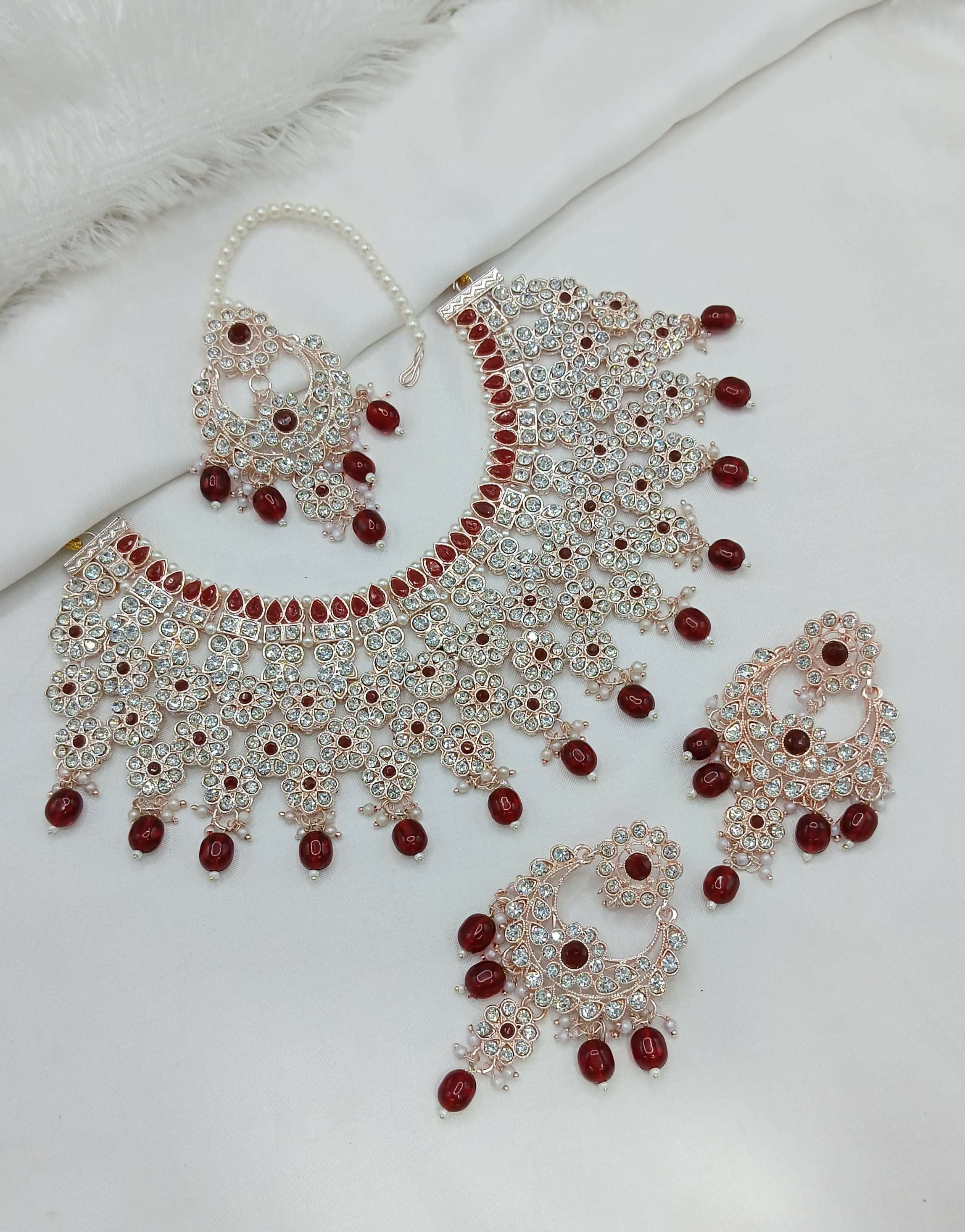 Broad maroon stone work necklace set featuring ornate design and matching jewelry