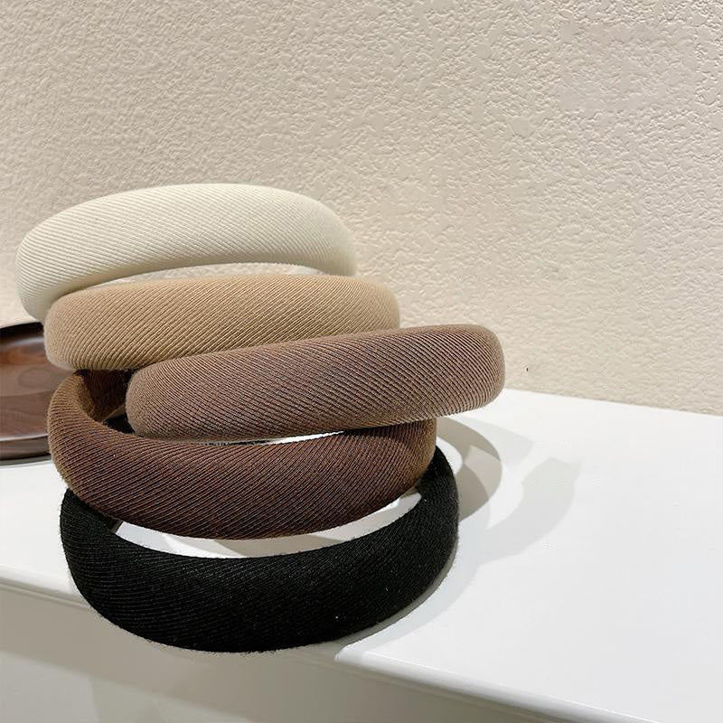 A collection of Japanese style wide padded headbands in khaki, brown, black, and cream, alongside a model wearing a brown headband, showcasing stylish comfort.