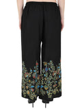 Black palazzo pants featuring a subtle floral pattern