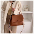 A simple leather crossbody messenger bag for girls in a modern, elegant style.