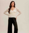 Off White pointelle knit sweater top with a front tie waist detail