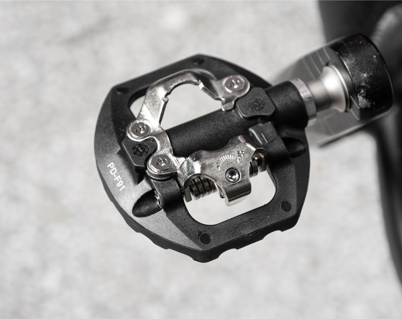 Black nylon clipless mountain and road bike pedals with cleats set