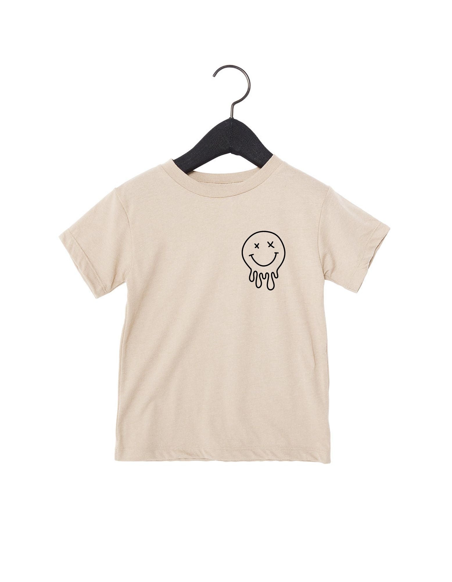 X-Eye smiley graphic tee available in beige or black, perfect for streetwear outfits.