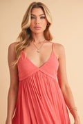 Model wearing a stylish ruched plunge mini cami dress with sculpted fit