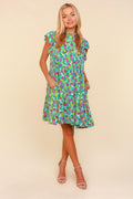 A feminine tiered ditsy floral dress with a frilled mock neck and pockets