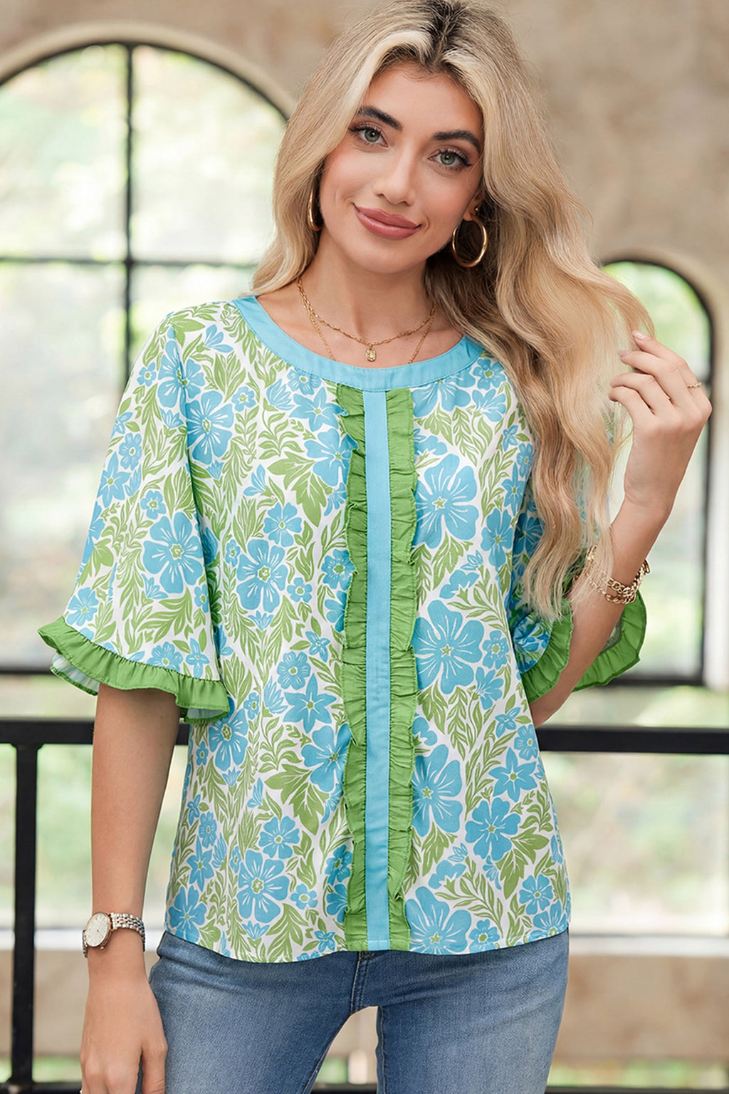 Waverly half-sleeve floral blouse with color-block trim in blue and green.