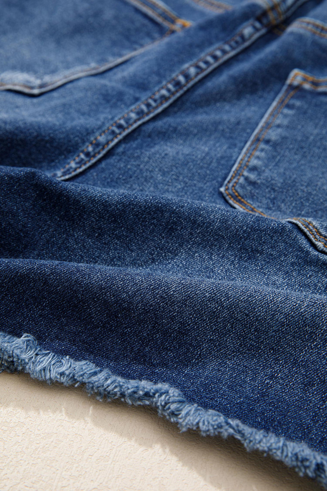 High-Waist Distressed Denim Asymmetric Raw Hem Shorts in Blue