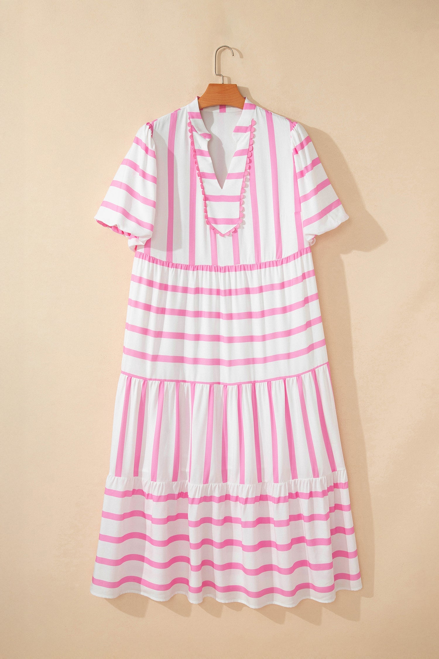 Pink and white striped tiered maxi dress with puff sleeves and a V-neckline.
