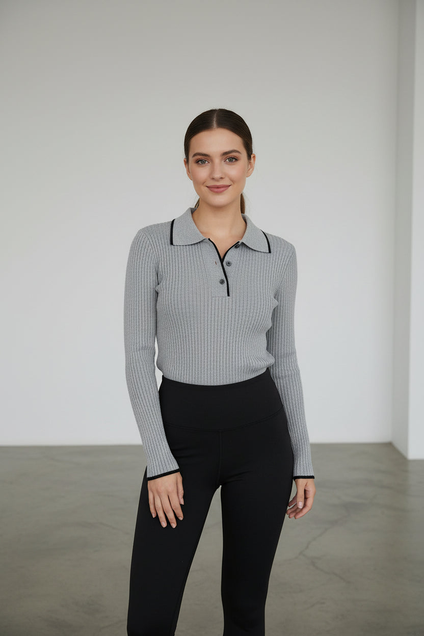 Model wearing a grey long sleeve ribbed knit polo shirt with black contrast trim.