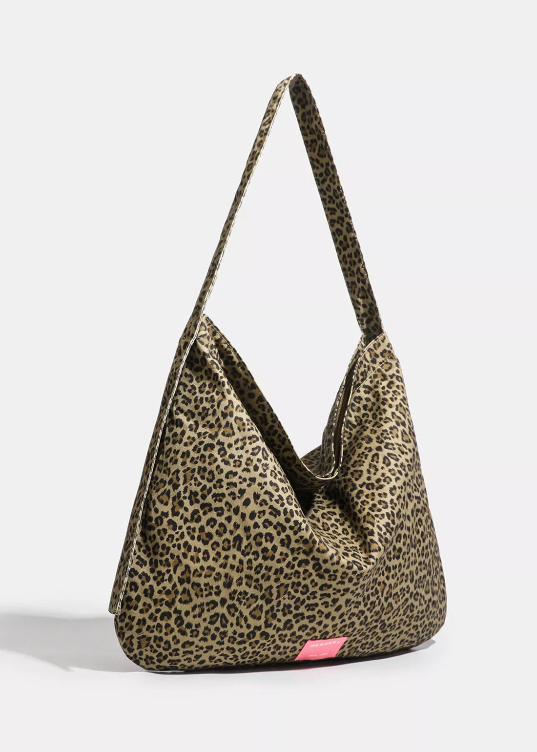 Leopard print handbag with a pink tag on a white background