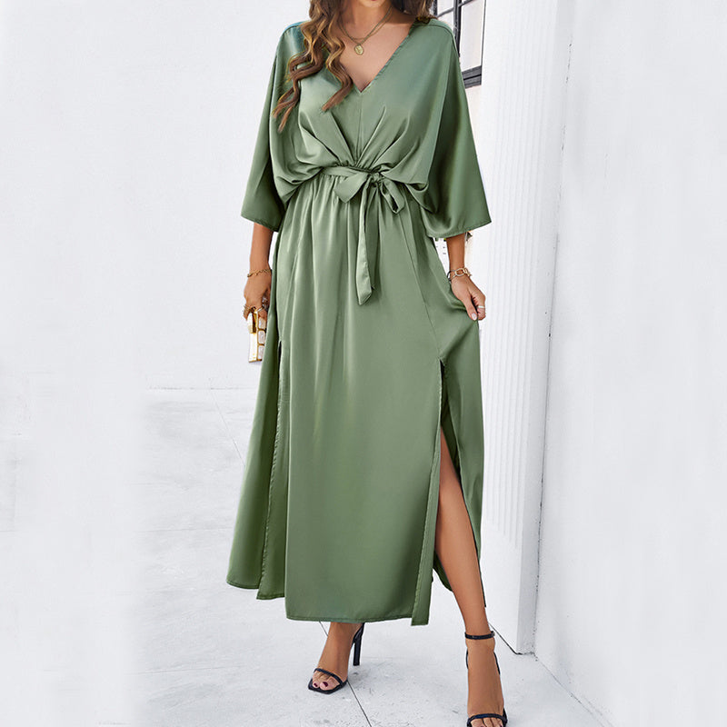 A romantic long dress with bat sleeves, v-neckline, and side split design in solid color, featuring a high-waist lace-up detail.